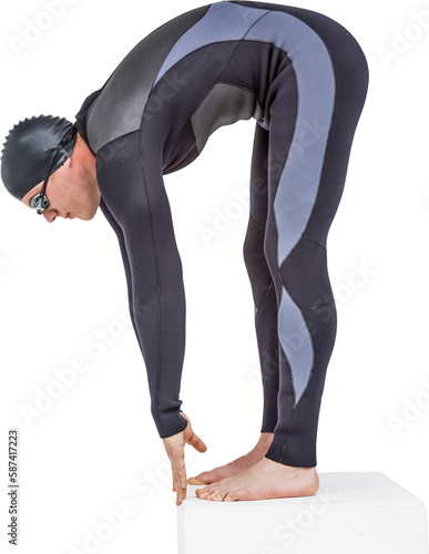 Swimmer in wetsuit preparing to dive