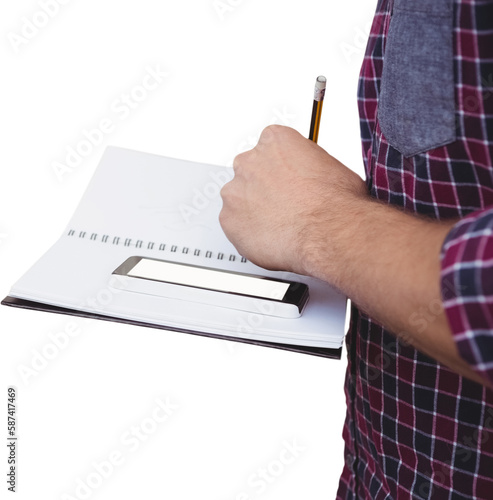 Cropped image of man with smartphone writing on book