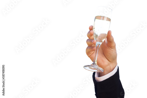 Hand raising champagne glass against clear sky