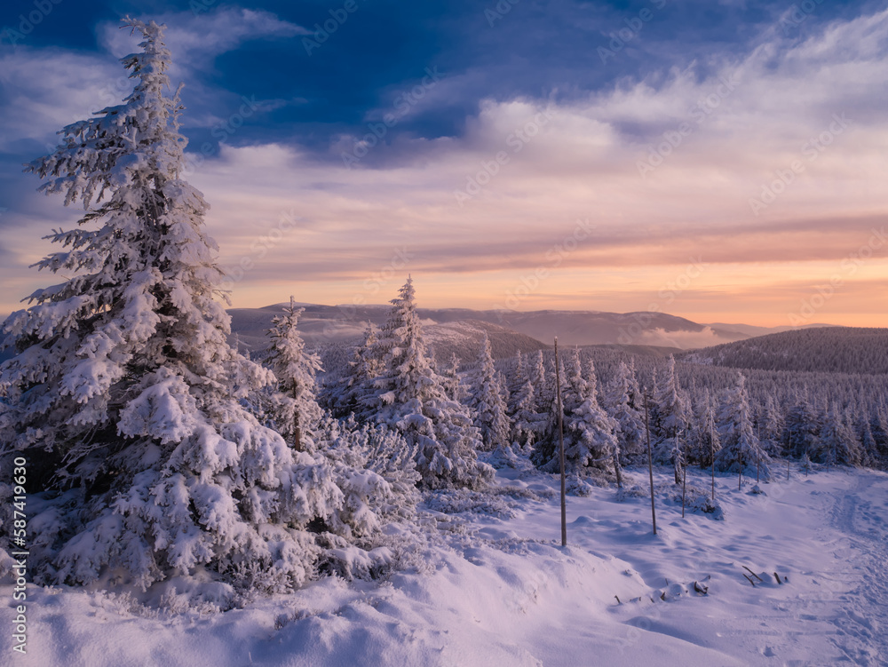 Scenic snowy landscape with a view from a mounatin range to the valley