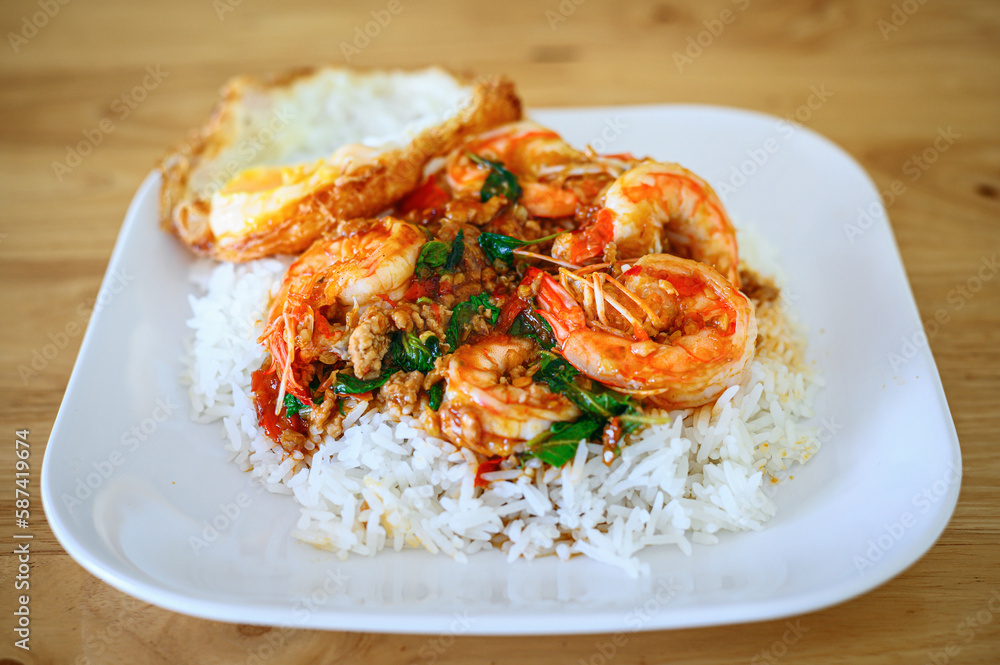 Rice topped with stir-fried prawns and basil leaves with Fried egg ,Thai food Rice topped with stir-fried prawns and basil leaves with Fried egg ,Thai food