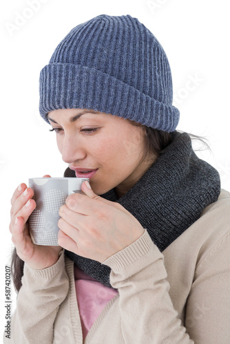 Smiling brunette drinking hot beverage