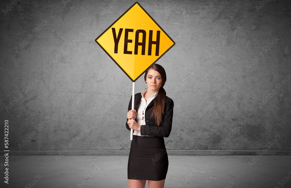 Young business person holding road sign Young business person holding road sign