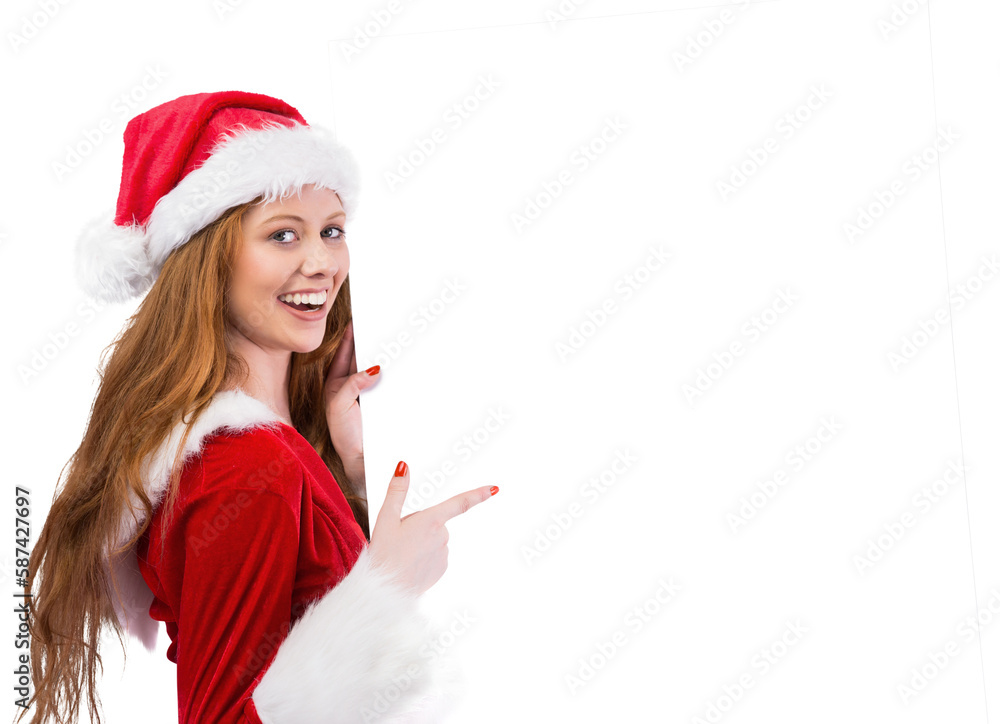 Festive redhead smiling at camera holding poster Festive redhead smiling at camera holding poster