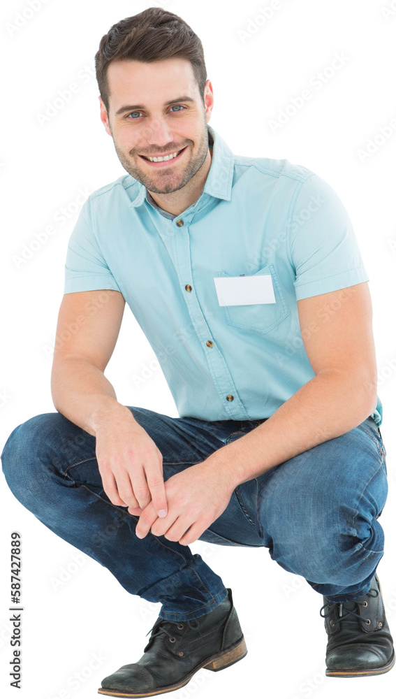 Handsome delivery man crouching on white background Handsome delivery man crouching on white background
