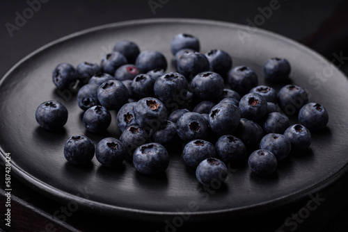 Delicious fresh blueberries on a textural black concrete background