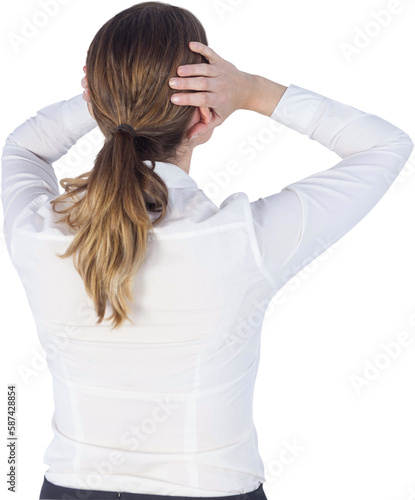 Businesswoman covering ears over white background