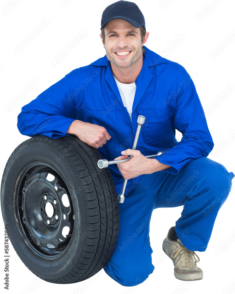 Mechanic leaning on tire while holding wheel wrenches Mechanic leaning on tire while holding wheel wrenches