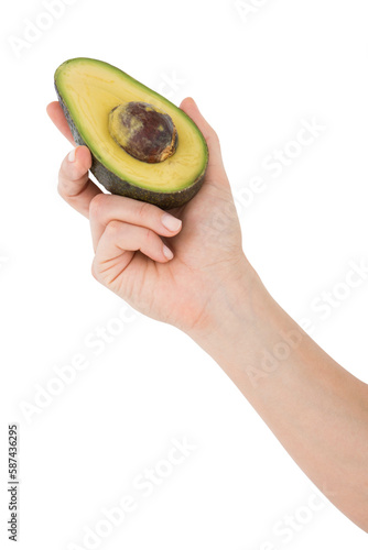 Woman holding half of an avocado 