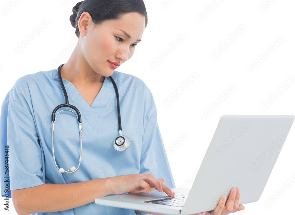 Concentrated surgeon using a laptop in hospital Concentrated surgeon using a laptop in hospital