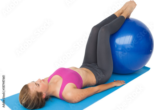 Full length of a fit woman exercising with fitness ball
