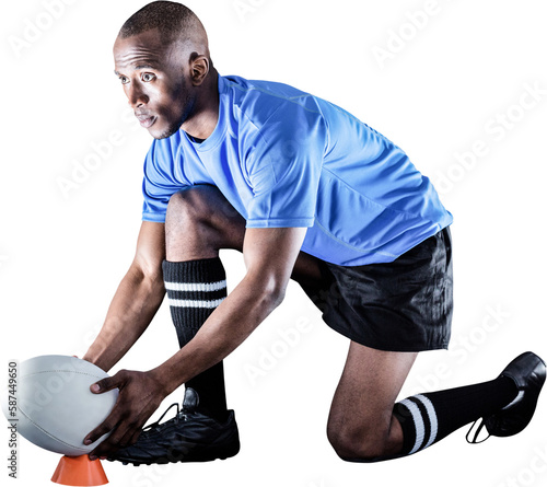 Rugby player looking away while keeping ball on kicking tee