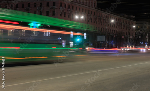 Car traffic at night on a city street.