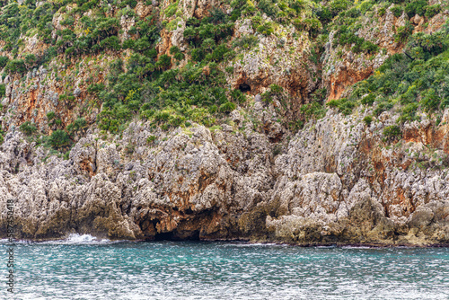 Beautiful views of the turquoise sea surrounded by huge rocky walls and mountain vegetation.