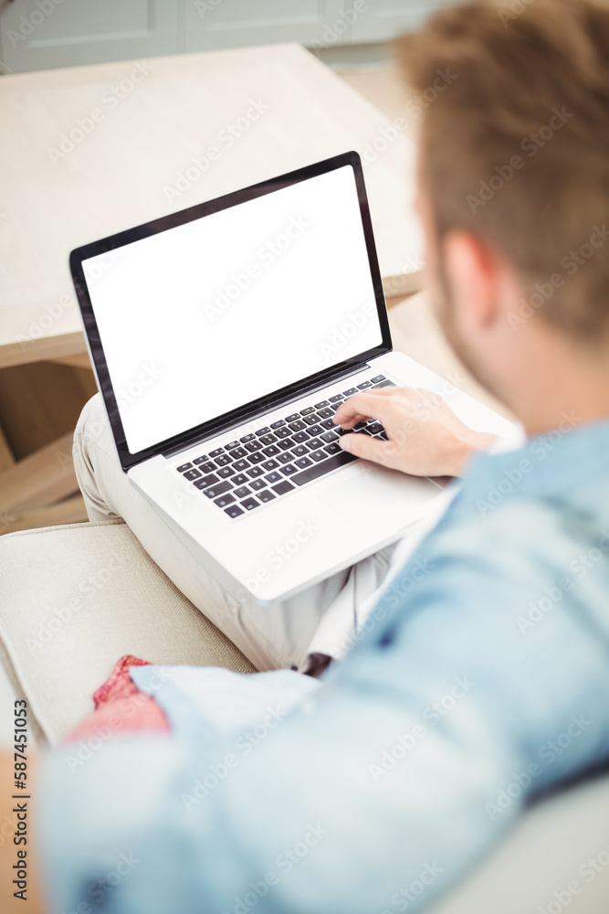 Young man using laptop at home Young man using laptop at home