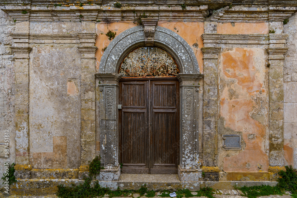 Very old dilapidated walls with old doors that no one is renovating.