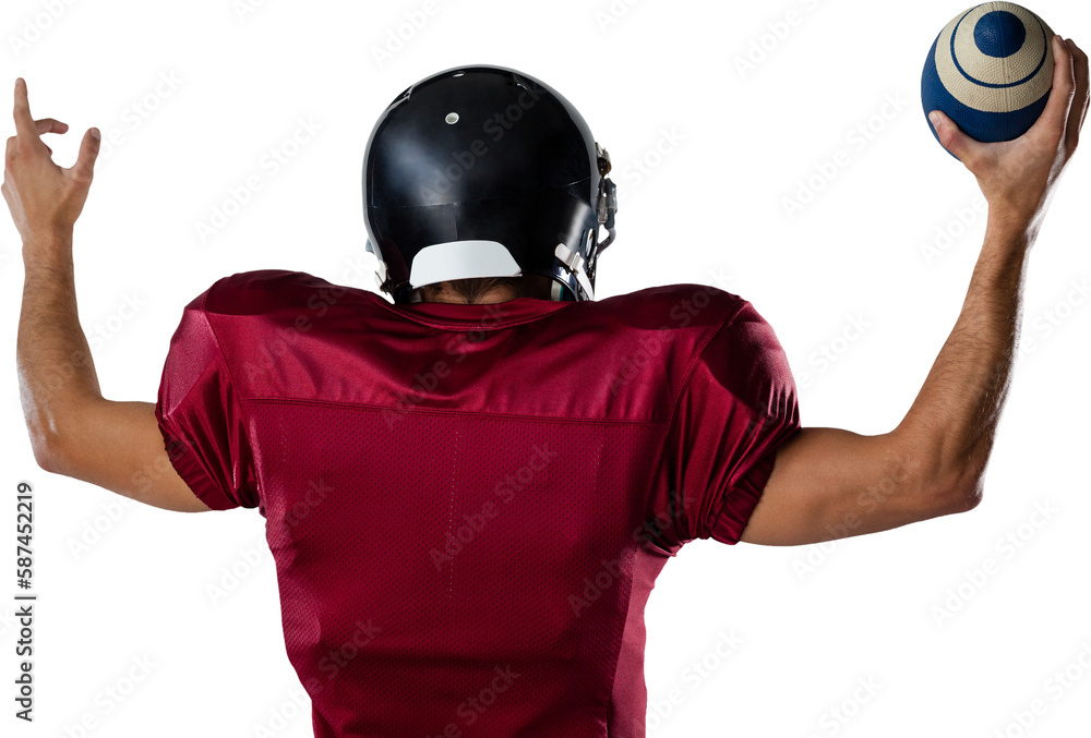 Rear view of player holding football with arms raised