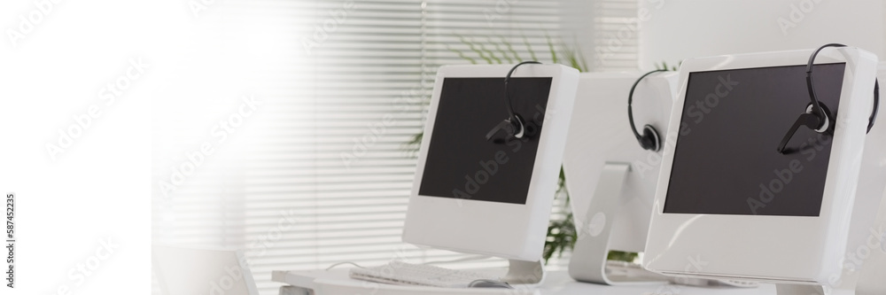 Fototapeta premium Computers with headphones on table