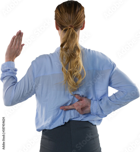 Businesswoman taking false oath with finger crossed photo