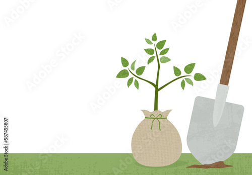 Grunge Arbor Day tree sapling bundled in burlap with shovel and copy space
