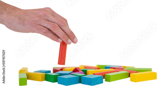 Cropped hand arranging blocks