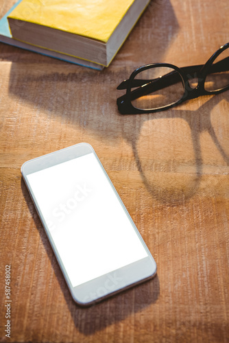 Close up view of smartphone and glasses