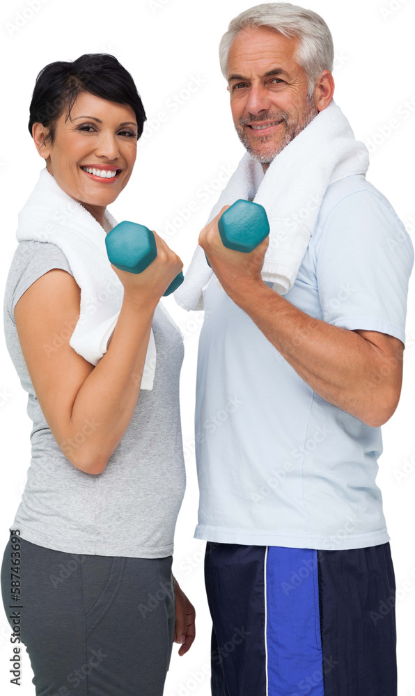 Portrait of a fit mature couple exercising with dumbbells Portrait of a fit mature couple exercising with dumbbells