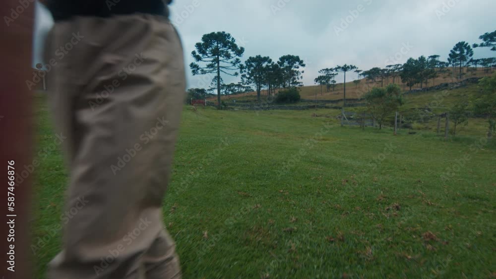 Angler in waders walks at early morning to fishing and trespassing the farm