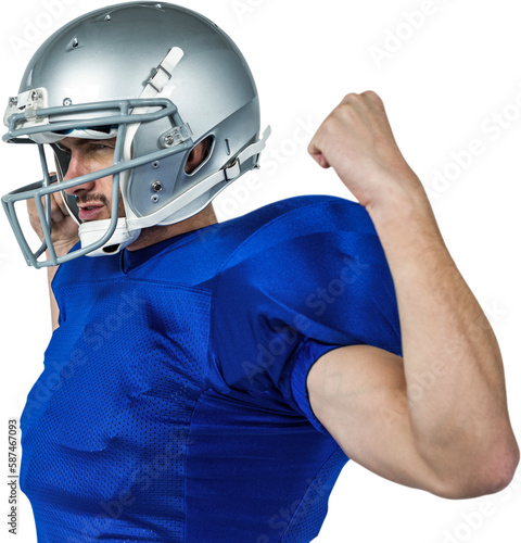 Confident American football player flexing muscles