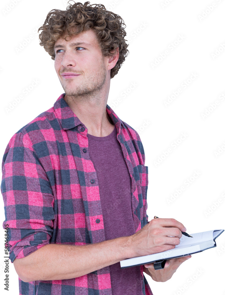 Handsome man looking away while writing on book Handsome man looking away while writing on book