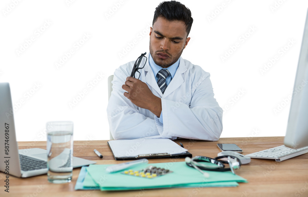 Doctor looking medical report at desk Doctor looking medical report at desk