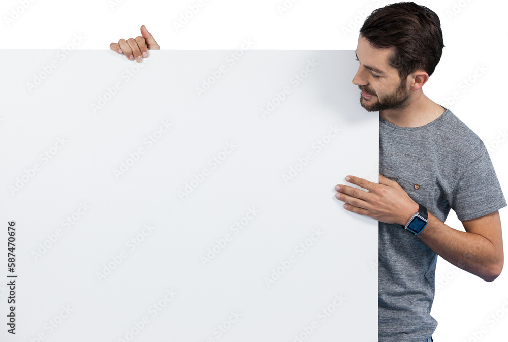Smiling young man holding placard against white background Smiling young man holding placard against white background