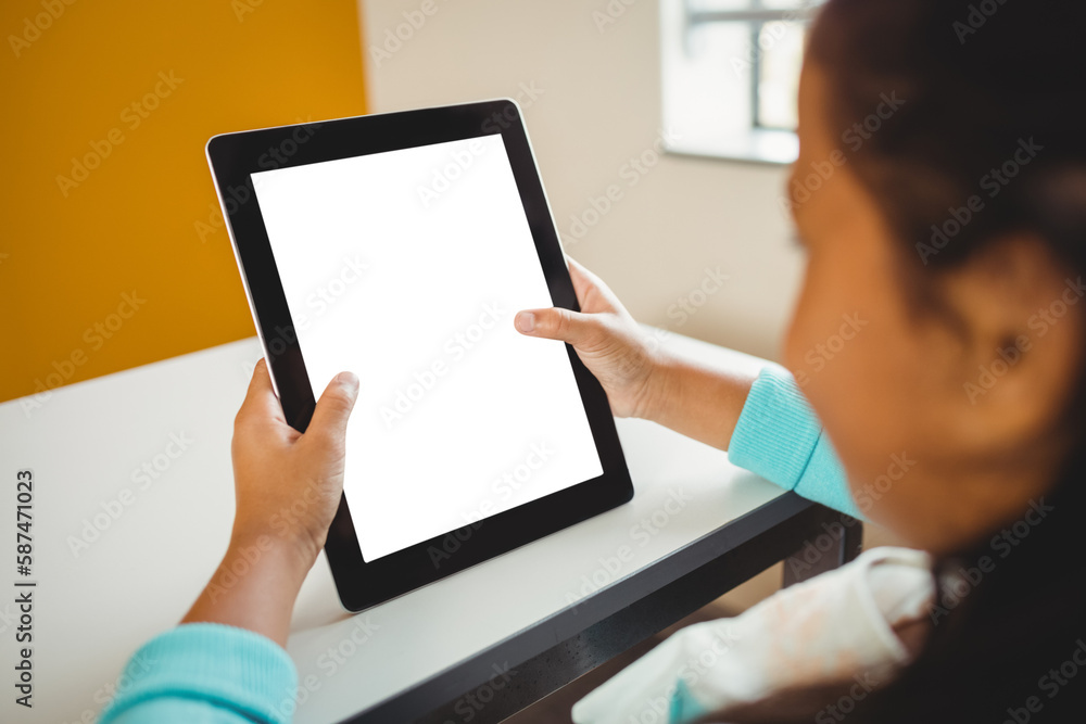 Girl sitting and using digital computer