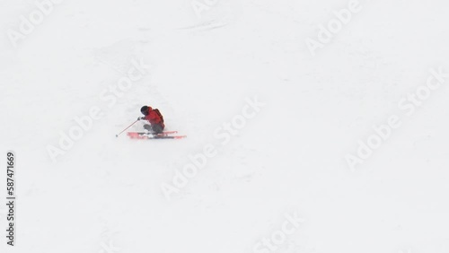 Skier going down on slope for free style downhill up at alps mountain summit at high altitude