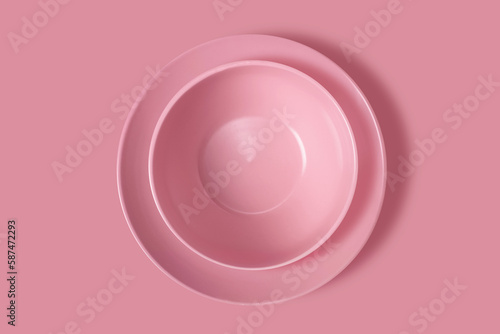 Two pink plates on a pink background. View from above. Concept