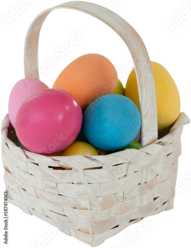Mulit colored Easter eggs in wicker basket photo