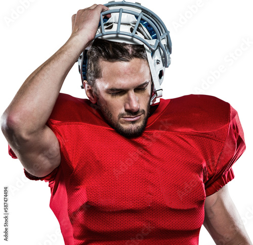 American football player in removing helmet