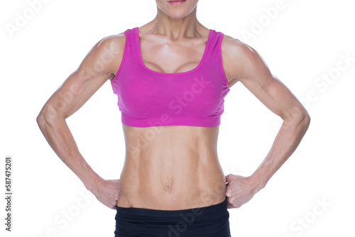 Fotografie Female bodybuilder posing in pink sports bra and shorts mid section