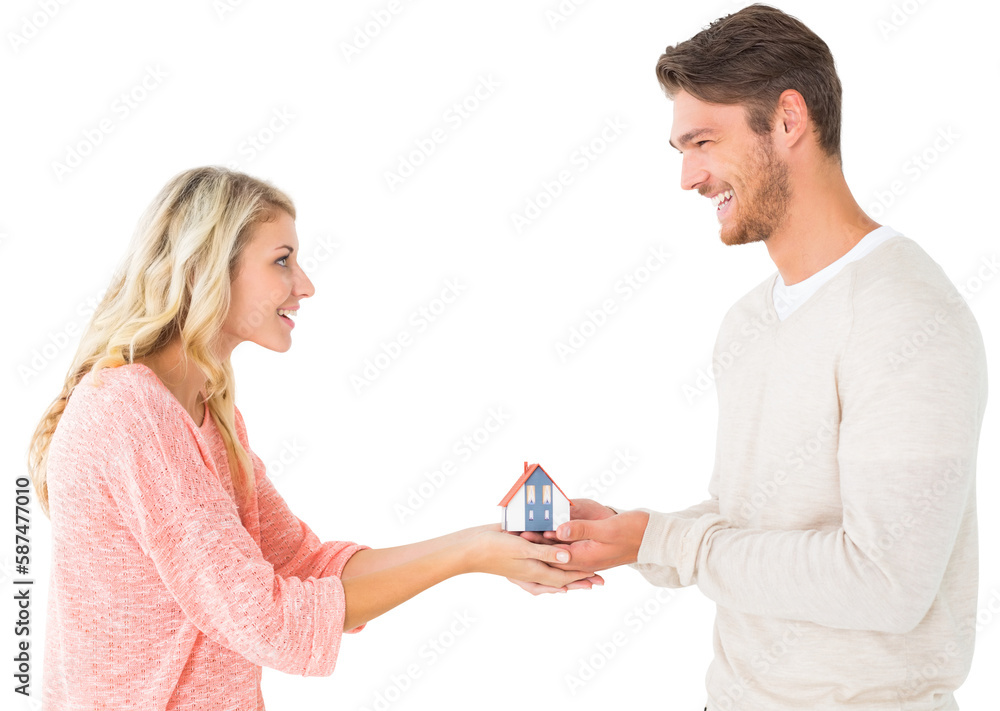 Attractive couple holding miniature house model Attractive couple holding miniature house model