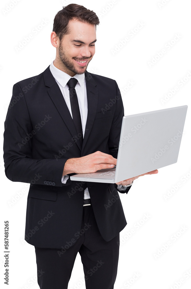 Smiling businessman standing and using laptop Smiling businessman standing and using laptop