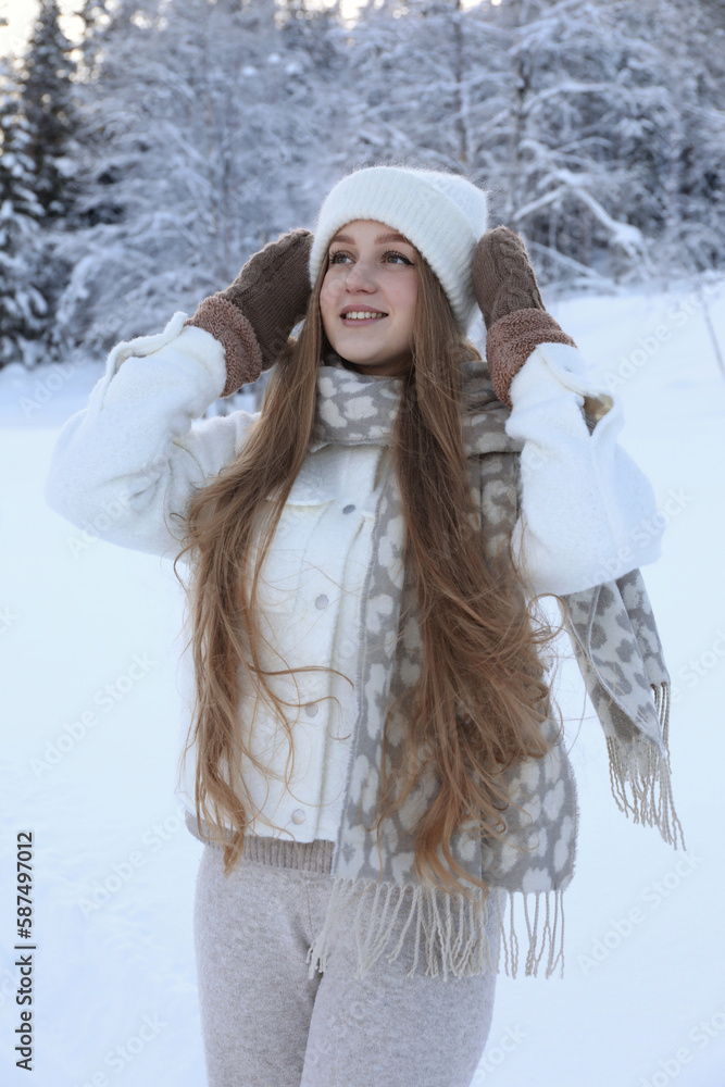 Winter vacation. Smiling woman near snowy forest outdoors Winter vacation. Smiling woman near snowy forest outdoors