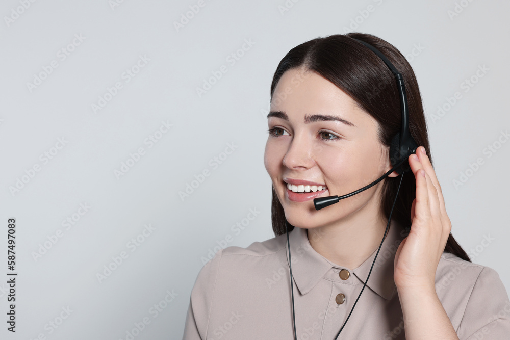 Hotline operator with modern headset on light grey background, space for text. Customer support Hotline operator with modern headset on light grey background, space for text. Customer support