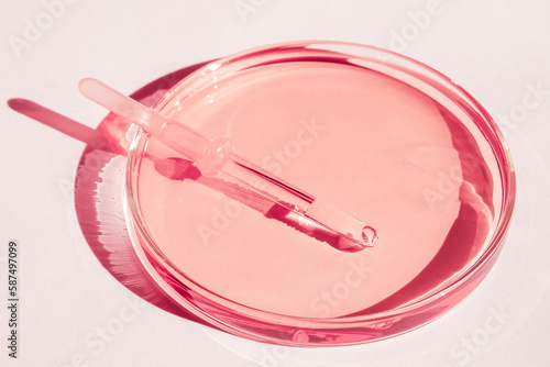 Petri dishes. With pink liquid. With solution. Medical pipette. On a white background.