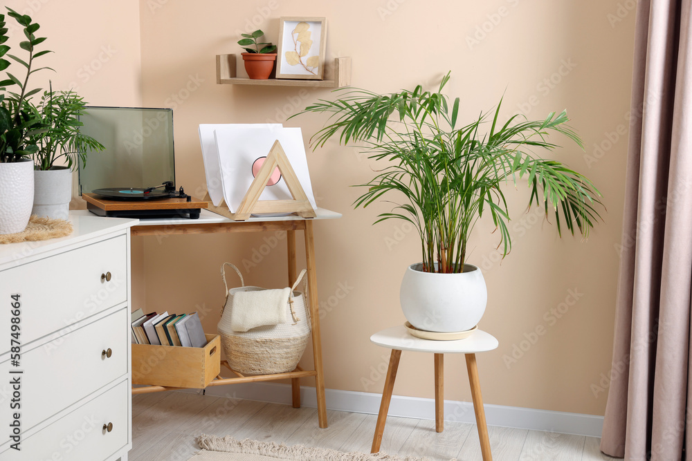 Stylish turntable with vinyl record on console table in cozy room Stylish turntable with vinyl record on console table in cozy room