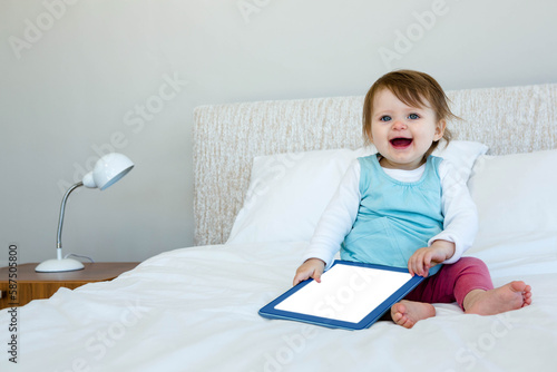 Baby holding digital tablet