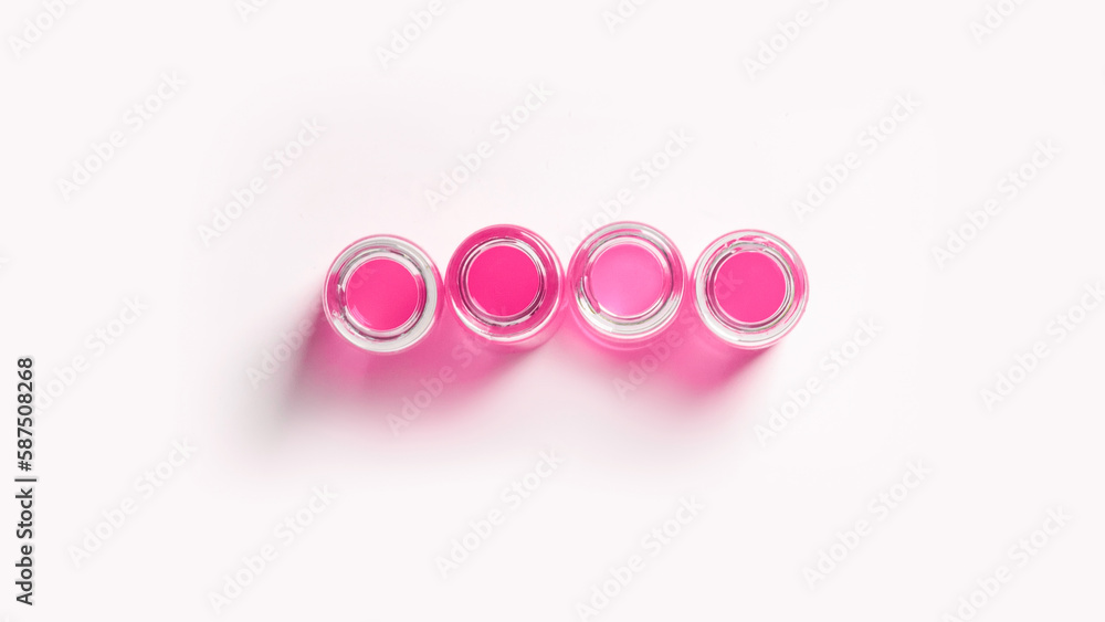 set of flasks, laboratory jars with pink liquid. On a white, light background. View from above. set of flasks, laboratory jars with pink liquid. On a white, light background. View from above.
