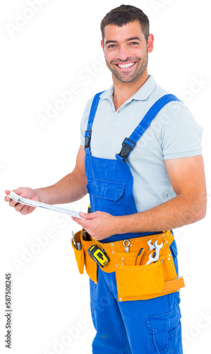 Happy carpenter in overalls holding clipboard