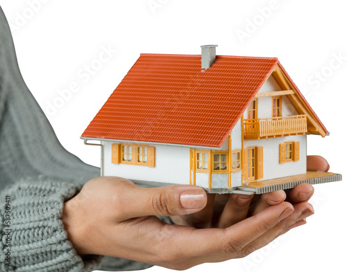 Hands showing a miniature model home
