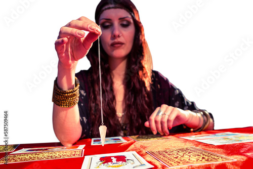 Female fortune teller holding pendulum with eyes closed 