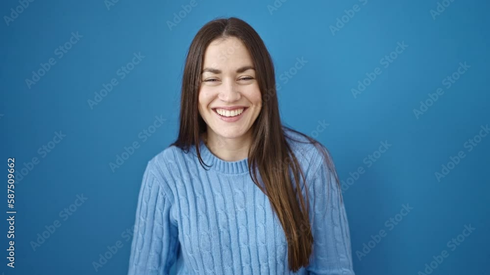 Young caucasian woman smiling confident standing over isolated blue background Young caucasian woman smiling confident standing over isolated blue background